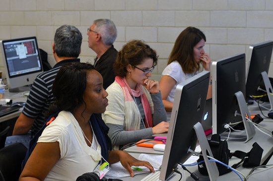 dmac participants at computers working on video production